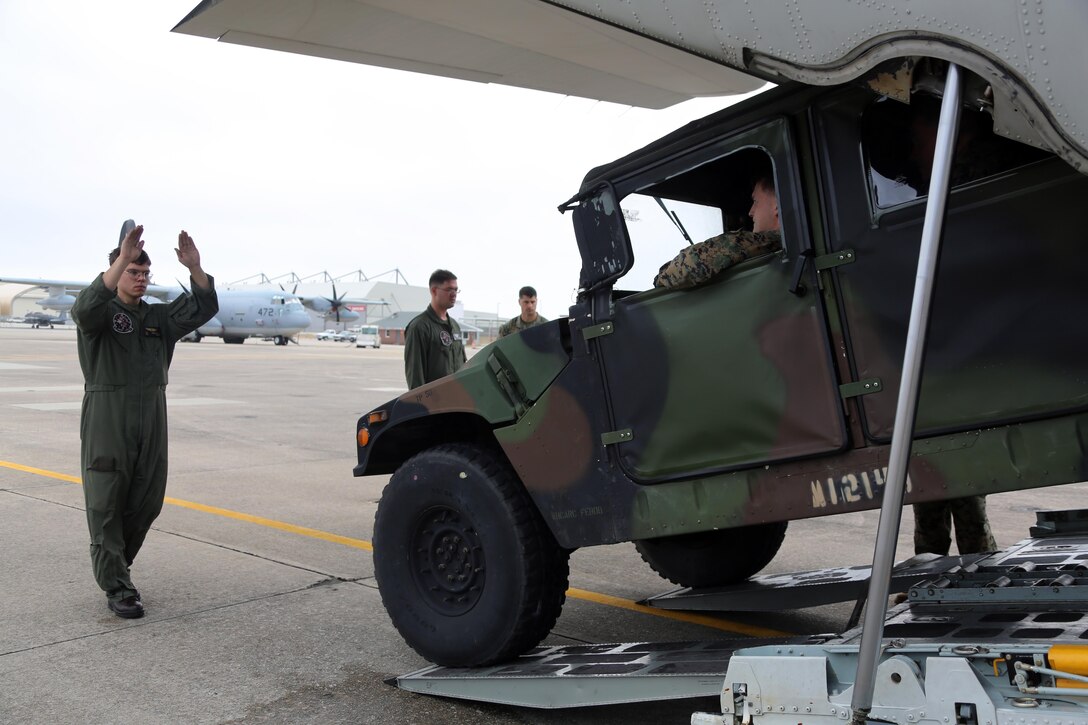 Marines load a Humvee onto a KC-130J Super Hercules during cargo transportation for exercise Eager Response at Marine Corps Air Station Cherry Point, N.C., Feb. 24, 2016.  During the exercise, Marines trained in events such as casualty evacuation, assault support missions and aerial refueling, proving the 2nd Marine Aircraft Wing is a highly effective combat force. (U.S. Marine Corps photo by Cpl. N.W. Huertas/ Released)