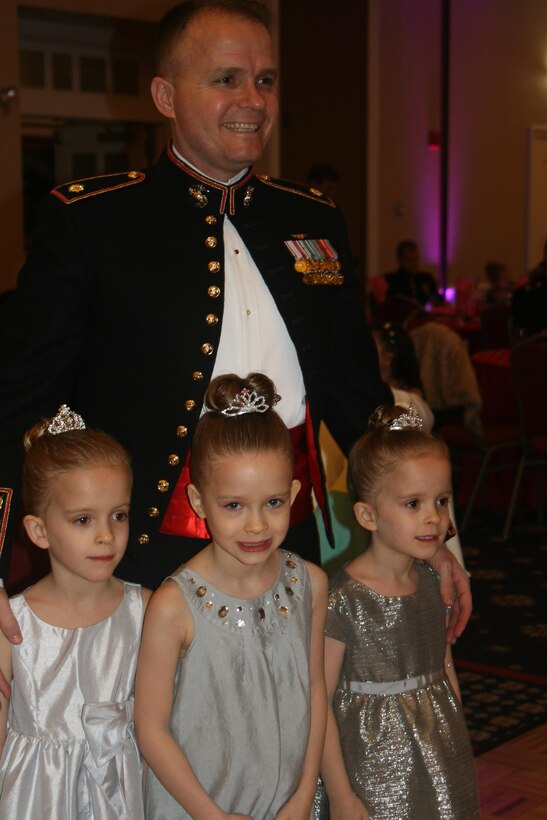Maj. Ed Blackshaw, currently at Marine Corps University, poses with his triplet daughters Emma, Julia, and Sarah, 6.