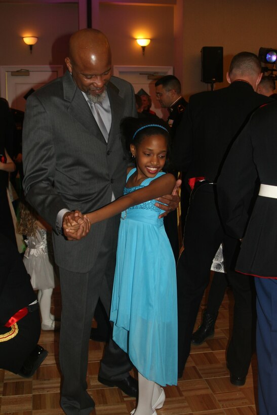 Retired Marine Vincent Wright dances with his daughter Jada, 10.