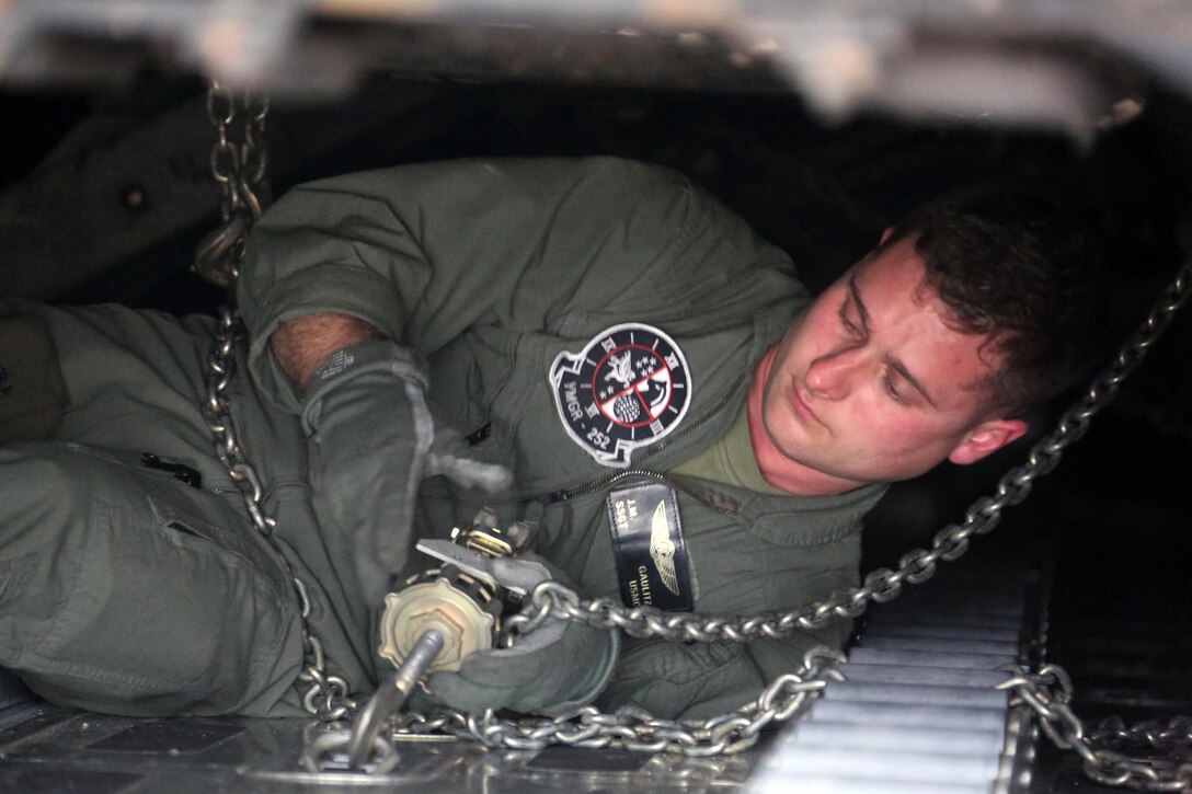 Staff Sgt. Jeremiah Gaulitz secures a Humvee to the deck of a KC-130J Super Hercules during cargo transportation for exercise Eager Response at Marine Corps Air Station Cherry Point, N.C., Feb. 24, 2016.  During the exercise, Marines trained in events such as casualty evacuation, assault support missions and aerial refueling, proving the 2nd Marine Aircraft Wing is a highly effective combat force. Gaulitz is a crew master with VMGR-252. (U.S. Marine Corps photo by Cpl. N.W. Huertas/ Released) 