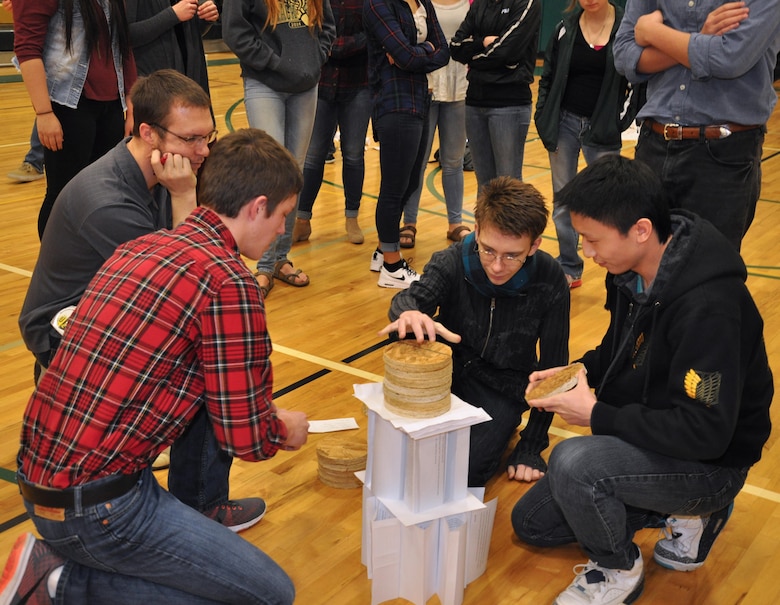 DeSales High School sophomore JD Deal applyies weights while Jeff Lyon, a Walla Walla Distict U.S. Corps of Engineers volunteer, and his senior
partners Steven Yang and John Crowley look on.
