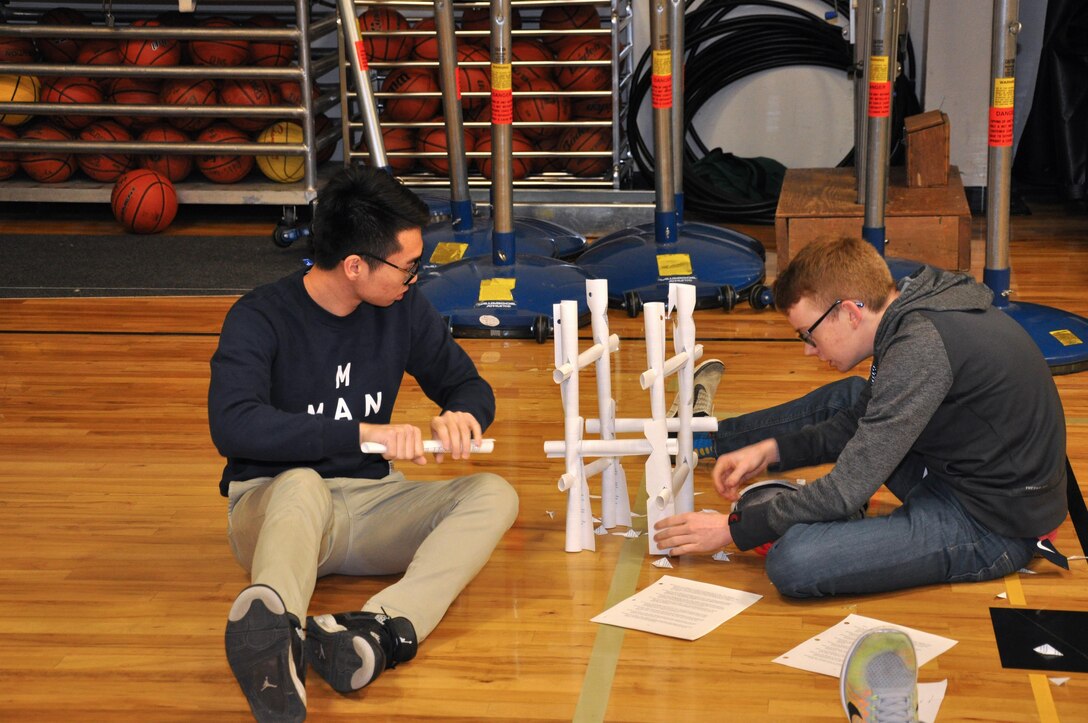 DeSales High School seniors Steven Xiao and Kyler Dunn construct their tower out of 25 sheets of copy paper. DeSales Students participated in this engineering competition as part of the national Engineering Week campaign. 