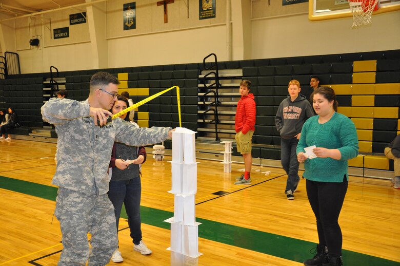 DeSales High School freshmen Aly Fazzari and Emily Hamada watch as their paper tower gets measured by Jeff Lyon, a Walla Walla Distict U.S. Corps of Engineers volunteer.