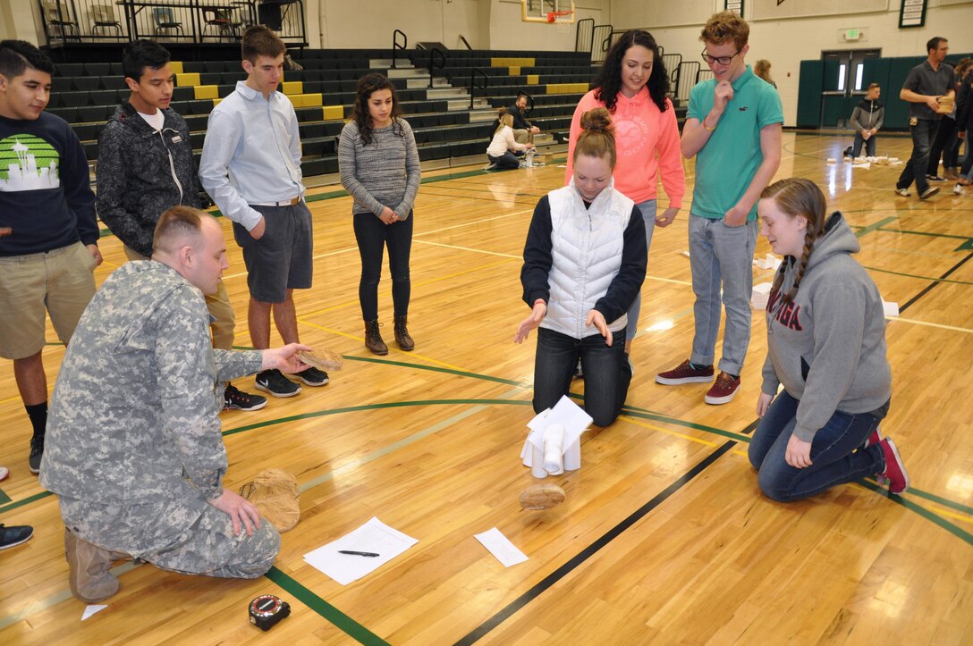 DeSales High School sophomores Maddy Thomas and Mary Ann Holtzinger watch as their paper tower collapses from the weight.