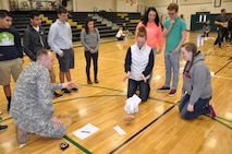 DeSales High School sophomores Maddy Thomas and Mary Ann Holtzinger watch as their paper tower collapses from the weight.