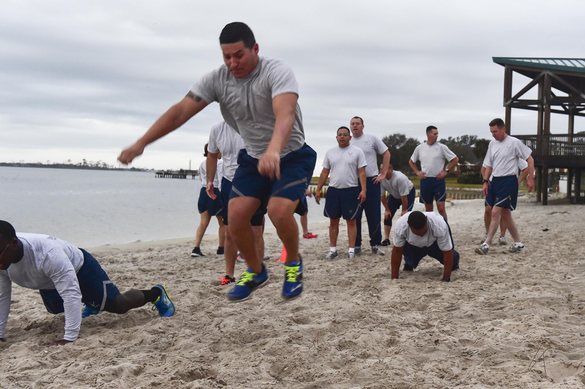 Senior Master Sgt. Eduardo Beltran, maintenance superintendent with the 801st Special Operations Aircraft Maintenance Squadron, performs a frog jump during a physical training session at the marina at Hurlburt Field, Fla., Feb. 23, 2016. Air Force Special Operations Command’s newest chief master sergeant selects and their command chiefs came to Hurlburt for a week long Chief orientation to help the new chiefs prepare for increased responsibilities as the top one percent of the enlisted force. (U.S. Air Force photo by Senior Airman Jeff Parkinson)