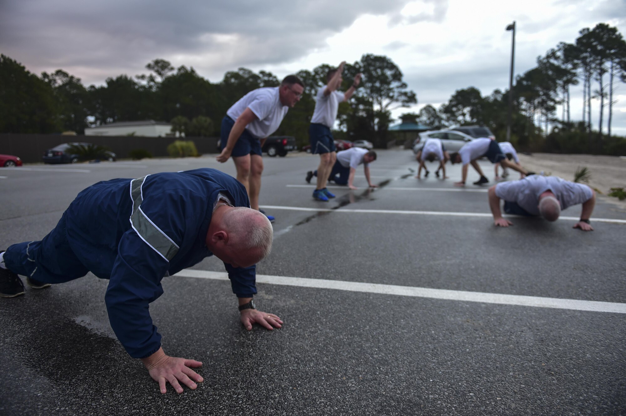 Senior Master Sgt. Ray Yurista, operations and maintenance supervisor for the 201st RED HORSE Squadron, Fort Indiantown Gap, Penn., does a burpee during a physical training session at the marina at Hurlburt Field, Fla., Feb. 23, 2016. Air Force Special Operations Command’s newest chief master sergeant selects and their command chiefs came to Hurlburt for a week long Chief orientation to help the new chiefs prepare for increased responsibilities as the top one percent of the enlisted force. (U.S. Air Force photo by Senior Airman Jeff Parkinson)