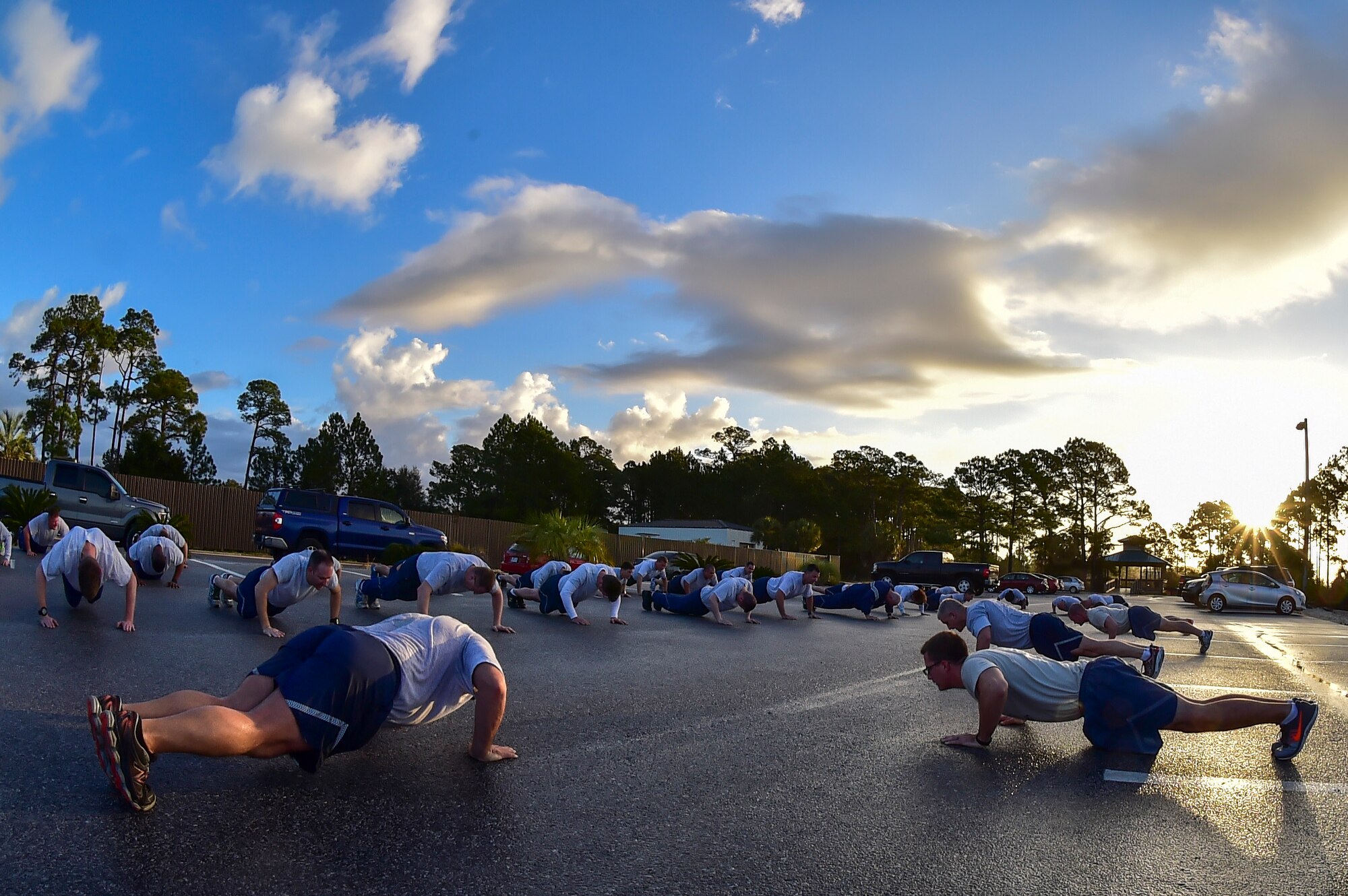 Air Force Special Operations Command’s command chiefs and newest Chief Master Sergeant selects perform memorial push-ups after a physical training session at the marina at Hurlburt Field, Fla., Feb. 23, 2016. Memorial push-ups honor those service members who lost their lives while serving. (U.S. Air Force photo by Senior Airman Jeff Parkinson)