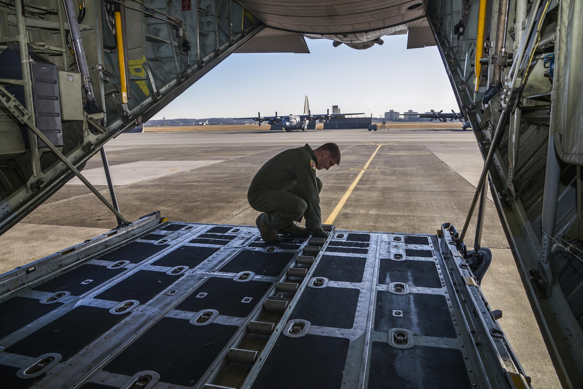 Senior Airman Christopher Hofer, 36th Airlift Squadron loadmaster, performs a preflight inspection at Yokota Air Base, Japan, March 2, 2016. Hofer and other loadmasters helped personnel with the 374th Operations Support Squadron survival, evasion, resistance and escape flight receive jump training. (U.S. Air Force photo by Senior Airman David Owsianka/Released)