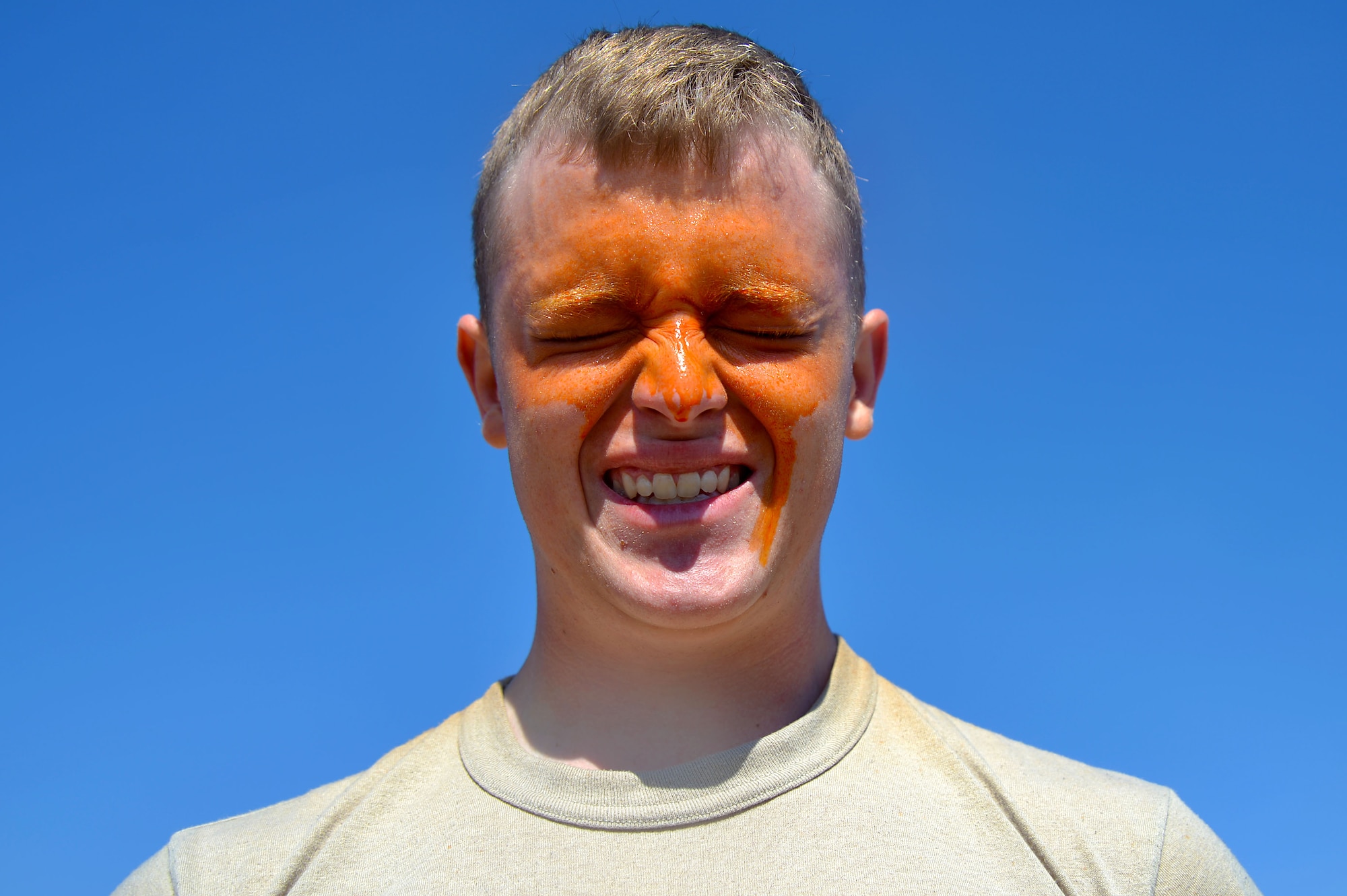 U.S. Air Force Airman 1st Class Dustyn Park, 20th Security Forces Squadron entry controller, counts to 10 after being pepper sprayed at Shaw Air Force Base, S.C., Feb. 29, 2016. Pepper spray is an inflammatory agent that can cause closing of the eyes, difficulty breathing, a runny nose, and coughing. (U.S. Air Force photo by Senior Airman Michael Cossaboom)