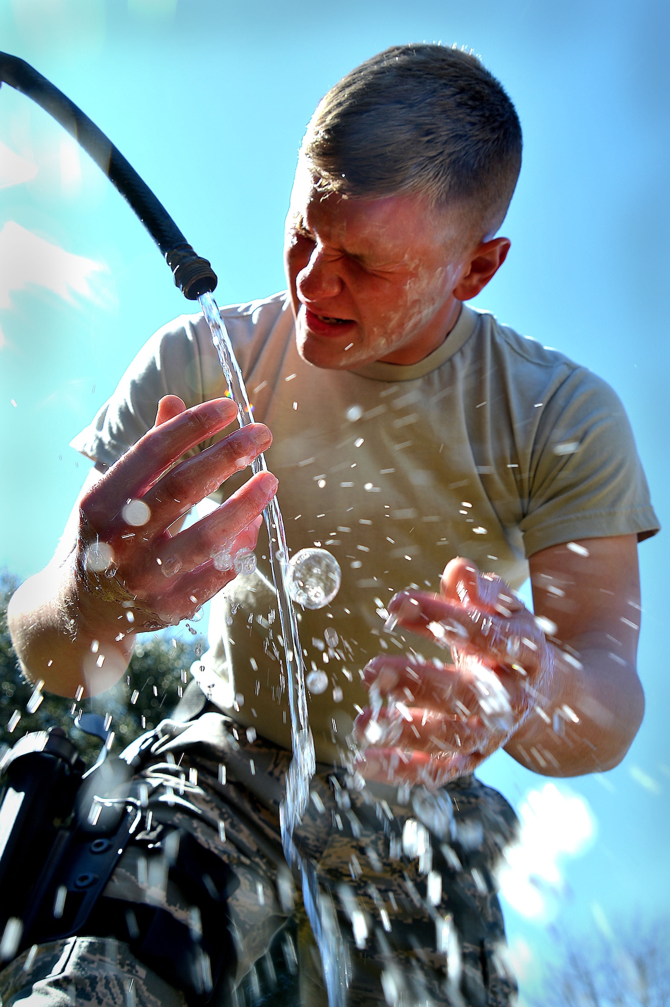 U.S Air Force Airman 1st Class Colin Patterson, 20th Security Forces Squadron entry controller, washes his face after pepper spray training at Shaw Air Force Base, S.C., Feb. 29, 2016. Pepper spray, also known as oleoresin capsicum, is made from the same naturally-occurring chemical that makes chili peppers hot, but at concentrations much higher and is used as a deterrent against perpetrators. (U.S. Air Force photo by Senior Airman Michael Cossaboom)