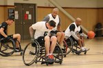 Spc. Jason Reed speeds down the court during the 2015 Army Trials wheelchair basketball practice session at Fort Bliss, Texas, March 23, 2015. The trials will be held next week.