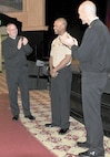 SAN ANTONIO (Feb. 18, 2016) Vice Adm. C. Forrest Faison III, left, Navy Surgeon General and Chief, Bureau of Medicine and Surgery (BUMED), and BUMED Force Master Chief Terry Prince, right, applaud following the announcement of the achievements of Hospital Corpsman 2nd Class Brandon Ponder, center, since he checked on board Navy Medicine Education and Training Command (NMETC). Faison presented Ponder with a coin as congratualtions during an all hands call on board Joint Base San Antonio - Fort Sam Houston, Texas. (U.S. Navy photo by Mass Communication Specialist 1st Class Jacquelyn D. Childs/Released)