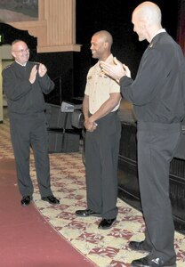 SAN ANTONIO (Feb. 18, 2016) Vice Adm. C. Forrest Faison III, left, Navy Surgeon General and Chief, Bureau of Medicine and Surgery (BUMED), and BUMED Force Master Chief Terry Prince, right, applaud following the announcement of the achievements of Hospital Corpsman 2nd Class Brandon Ponder, center, since he checked on board Navy Medicine Education and Training Command (NMETC). Faison presented Ponder with a coin as congratualtions during an all hands call on board Joint Base San Antonio - Fort Sam Houston, Texas. (U.S. Navy photo by Mass Communication Specialist 1st Class Jacquelyn D. Childs/Released)