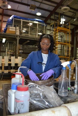 Dr. Catherine Thomas prepares soil samples for analysis during her research into the influence of different plants on the transport of heavy metals on Army firing ranges.