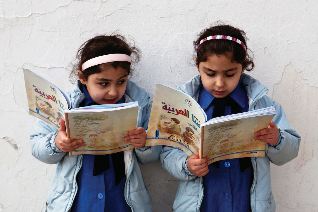 Young girls reading at a Jordanian primary school. Education and literacy are key elements of achieving gender equality.