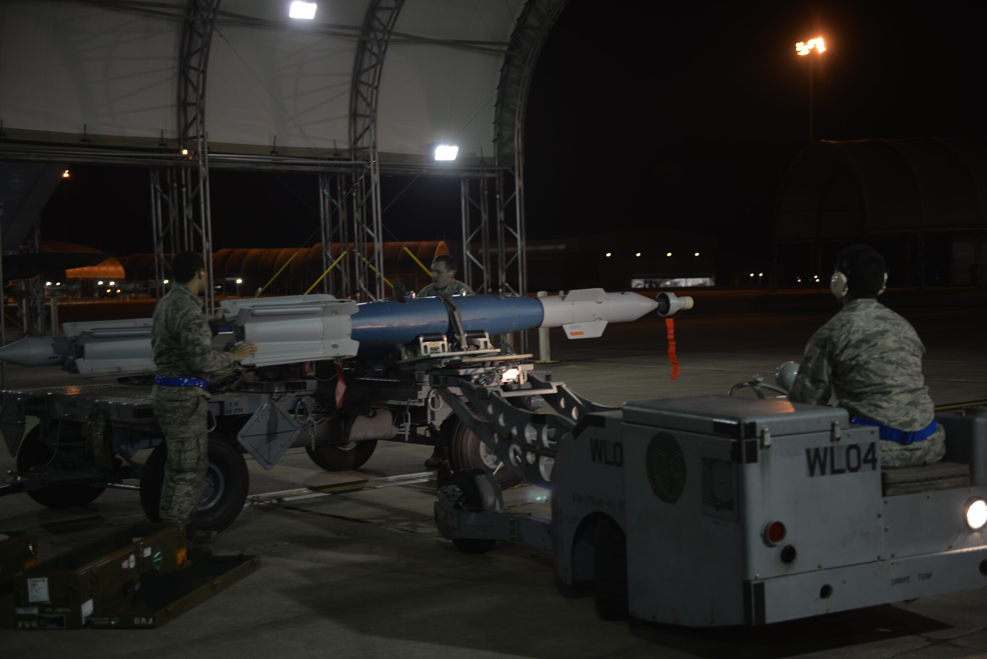 58th Aircraft Maintenance Unit weapons load crew members secure a GBU-12 to a jammer for transport to an F-35A Lightning II in the early morning March 3 at Eglin Air Force Base, Florida. This is the first time Airmen from the 33rd Fighter Wing loaded the munition into the F-35A for a weapons drop. (U.S. Air Force photo by 1st Lt Jenny Hyden)