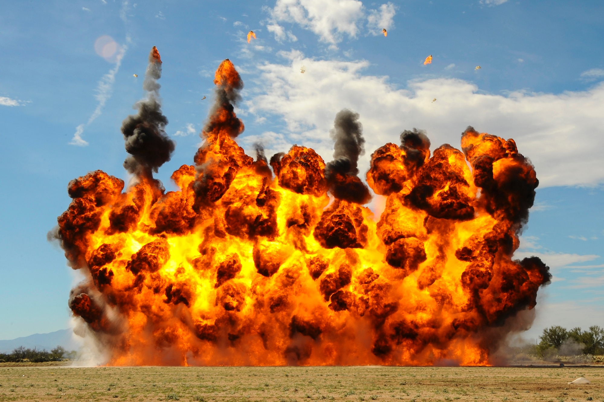 U.S. Airmen from the 355th Civil Engineer Squadron explosive ordnance disposal flight simulate an A-10C Thunderbolt II strafing run at Davis-Monthan Air Force Base, Ariz., Feb. 18, 2016. The EOD flight practiced for the demonstration they will display at the upcoming 2016 Thunder and Lighting over Arizona open house.  (U.S. Air Force photo by Airman 1st Class Mya M. Crosby/Released)