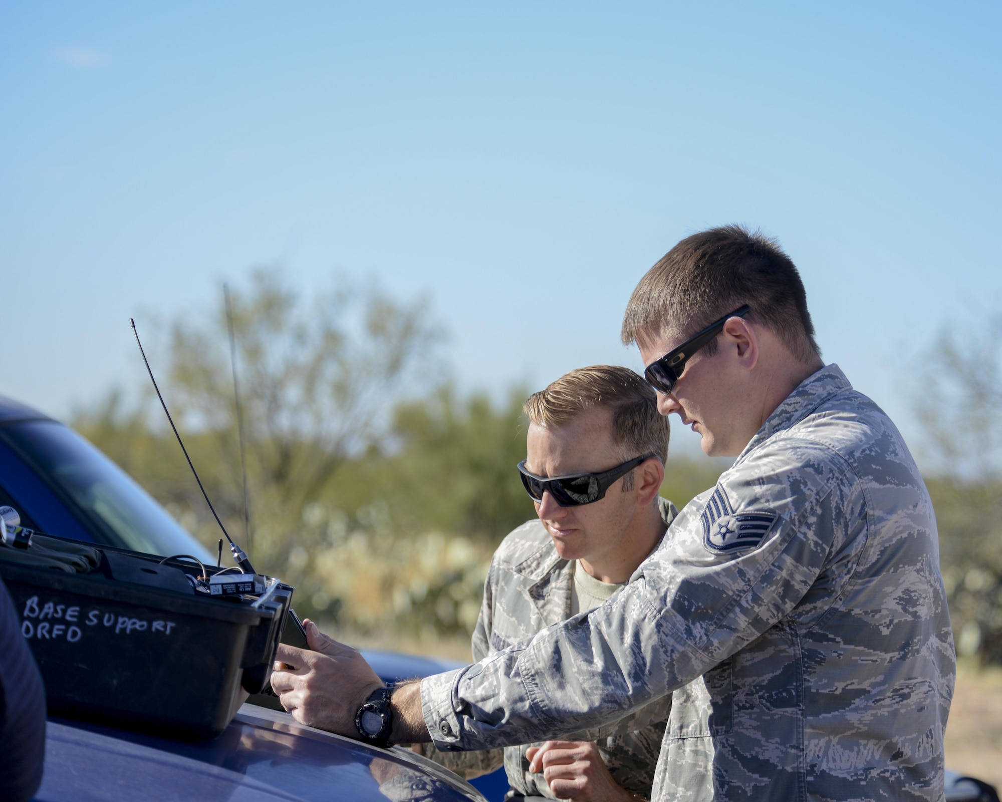 U.S. Air Force 355th Civil Engineer Squadron explosive ordnance technicians, Tech. Sgt. David Collins and Staff Sgt. Richard Weick, conduct a pre-operation check on a firing device at Davis-Monthan Air Force Base, Ariz., Feb. 18, 2016. The EOD flight practiced for the demonstration they will display at the upcoming 2016 Thunder and Lighting over Arizona open house.  (U.S. Air Force photo by Senior Airman Chris Massey/Released)