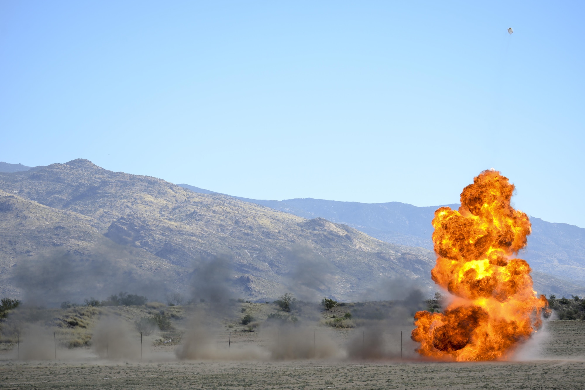 U.S. Airmen from the 355th Civil Engineer Squadron explosive ordnance disposal flight simulate an A-10C Thunderbolt II strafing run at Davis-Monthan Air Force Base, Ariz., Feb. 18, 2016.  The EOD flight practiced for the demonstration they will display at the upcoming 2016 Thunder and Lighting over Arizona open house.  (U.S. Air Force photo by Senior Airman Chris Massey/Released) 