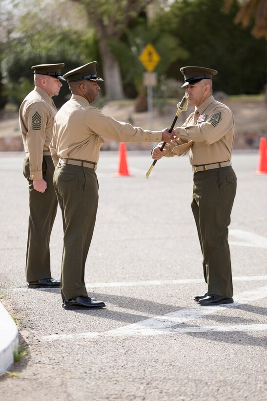 Sgt. Maj. Sergio Martinez accepts the Noncommissioned Officer sword from Base Commanding Officer, Col. Sekou S. Karega, designating him as the new base sergeant major, during a Relief and Appointment cermony held on MCLB Barstow, March 3. Sgt. Maj. Martinez took over the position from Sgt. Maj. Karl D. Simburger who has been reassigned as the sergeant major for the Wounded Warrior Regiment, located in Quantico, Va. 