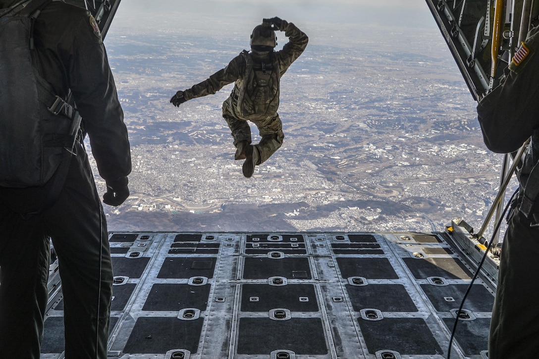 Air Force Tech. Sgt. Benjamin Jonas jumps out of a C-130 Hercules aircraft at 10,000 feet while flying over Yokota Air Base, Japan, March 2, 2016. Jonas, a noncommissioned officer in charge of survival, evasion, resistance and escape operations, is assigned to the 374th Operations Support Squadron. Air Force photo by Senior Airman David Owsianka