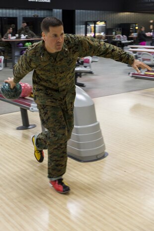Col. Robert V. Boucher, commanding officer of Marine Corps Air Station Iwakuni, bowls during the kickoff of the Navy-Marine Corps Relief Society’s active duty fund drive at the Strike Zone Bowling Center here Feb. 29, 2016. Since 1904, the NMCRS has provided assistance to Marines, Sailors and their families in times of need. By request of the commandant of the Marine Corps and the chief of naval operations, the NMCRS annually collects donations from active duty service members during March and April.
