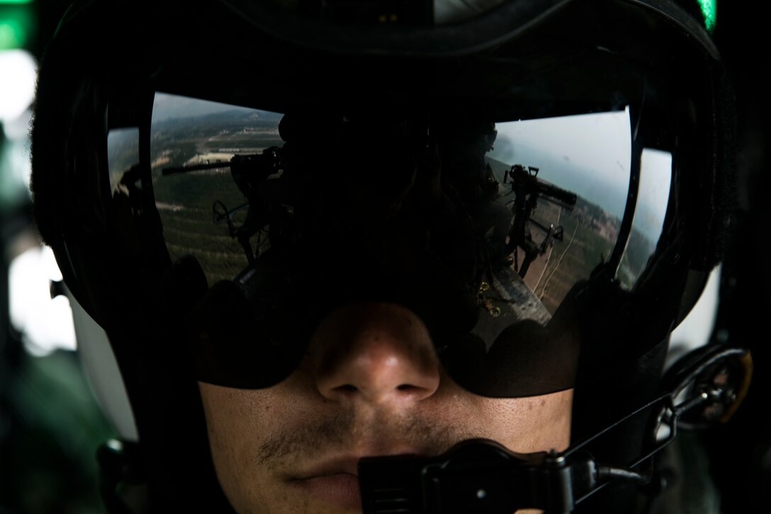 Lance Cpl. Rommi S. Swelam observes his fellow crew chiefs in a UH-1Y Huey during a flight as part of Cobra Gold 16 in Utapao, Thailand, Feb. 16, 2016. The Huey gives crew chiefs the advantage of having a “God’s eye” view of the environment below. Cobra Gold is a multi-national exercise designed to increase interoperability and cooperation of participating nations by working toward solutions to common challenges. Swelam, from Raleigh, N.C., is a crew chief with Marine Light Attack Helicopter Squadron 167 which is currently supporting Marine Aircraft Group 36, 1stj Marine Aircraft Wing, III Marine Expeditionary Force under the unit deployment program. (U.S. Marine Corps photo by Cpl. William Hester/ Released)
