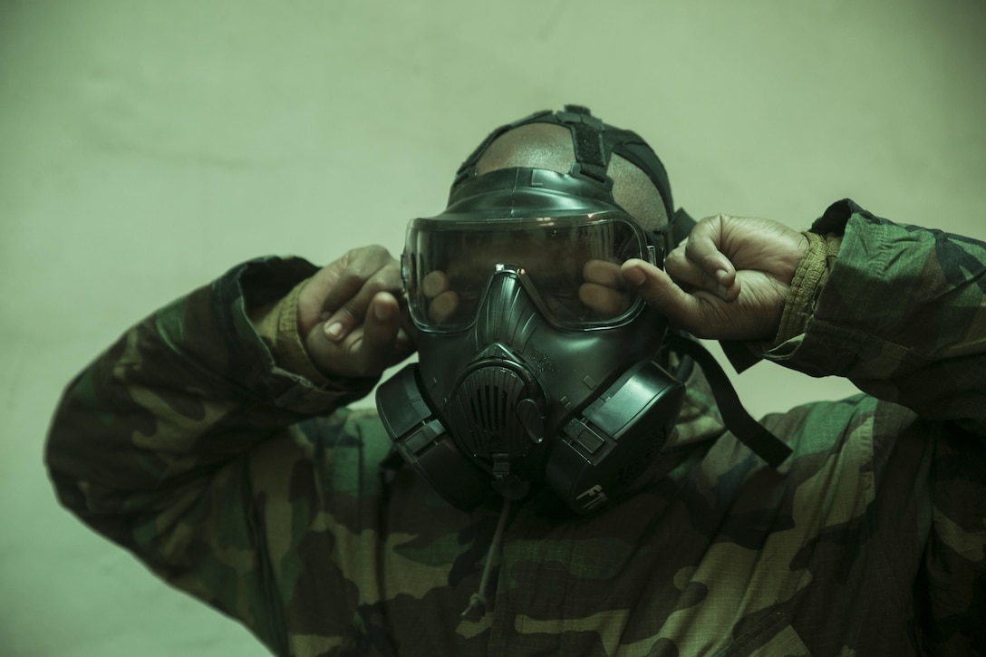 A U.S. Marine breaks the seal on his M50 Field Protective Joint Service General Purpose Mask during gas mask qualification at Gimpo Training Area, Republic of Korea, Feb. 25, 2016. The event took place as part of Korean Marine Exchange Program 16-6, a regularly scheduled training event between the ROK and U.S. Marine Corps. This iteration of KMEP focuses on specialized training between military policemen with 3rd Law Enforcement Battalion, III Marine Expeditionary Force Headquarters Group, III MEF, and Military Police Company, 2nd ROK Marine Corps Division. (U.S. Marine Corps Photo by Cpl. Steven Tran/Released)