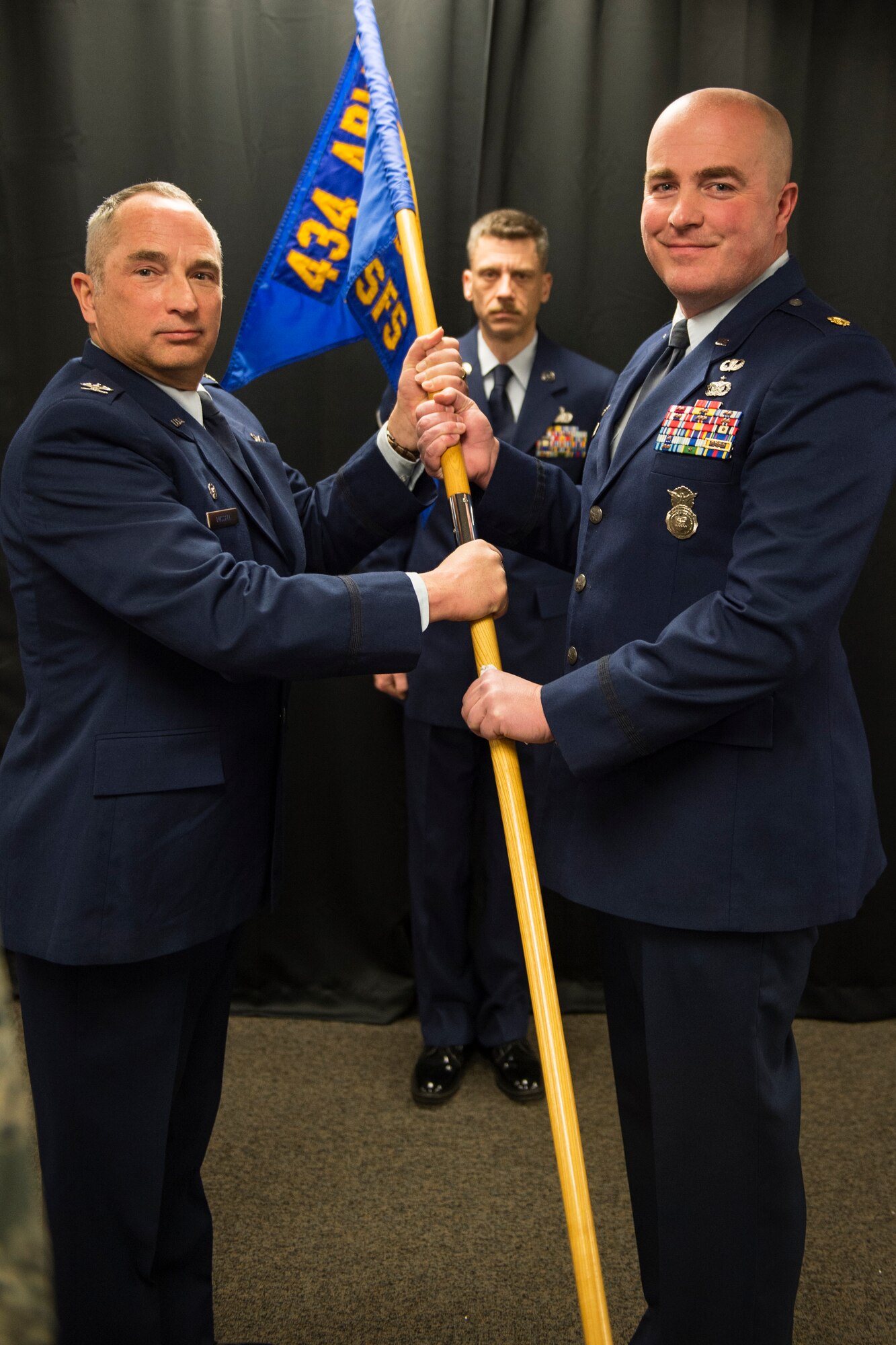 Maj. Matthew Garvelink, 434th Security Forces Squadron commander, receives the 434th SFS guidon from Col. Scott Russell, 434th Mission Support Group commander, during an assumption of command ceremony at Grissom Air Reserve Base, Ind., Feb. 6, 2016. The Michigan native holds a Bachelor’s of Science degree in criminal justice from Grand Valley State University, Allendale, Michigan and a Bachelor’s of Science degree in Biology from Hope College, Holland, Michigan. (U.S. Air Force photo/Tech. Sgt. Benjamin Mota)