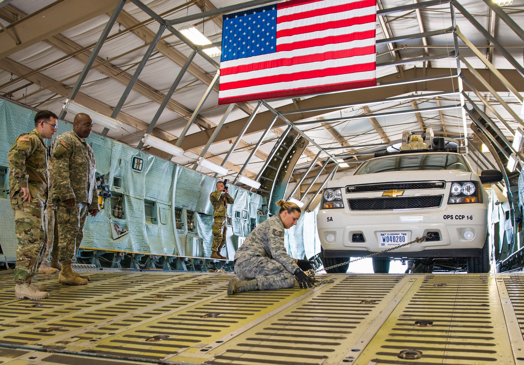 Tech. Sgt. Crystal Schiller, a 733rd Training Squadron air transportation specialist, inspects a chain tie-down during U.S. Army North's Task Force 51 quarterly deployment readiness training at the 433rd Airlift Wing's C-5 load trainer facility March 2, 2016 at Joint Base San Antonio-Lackland, Texas. Task Force 51 is responsible for overseeing Army reserve and active duty assets  in the event of a chemical, biological, radiological, nuclear, and explosives attack on U.S. soil.  (U.S. Air Force photo by Benjamin Faske) (released)