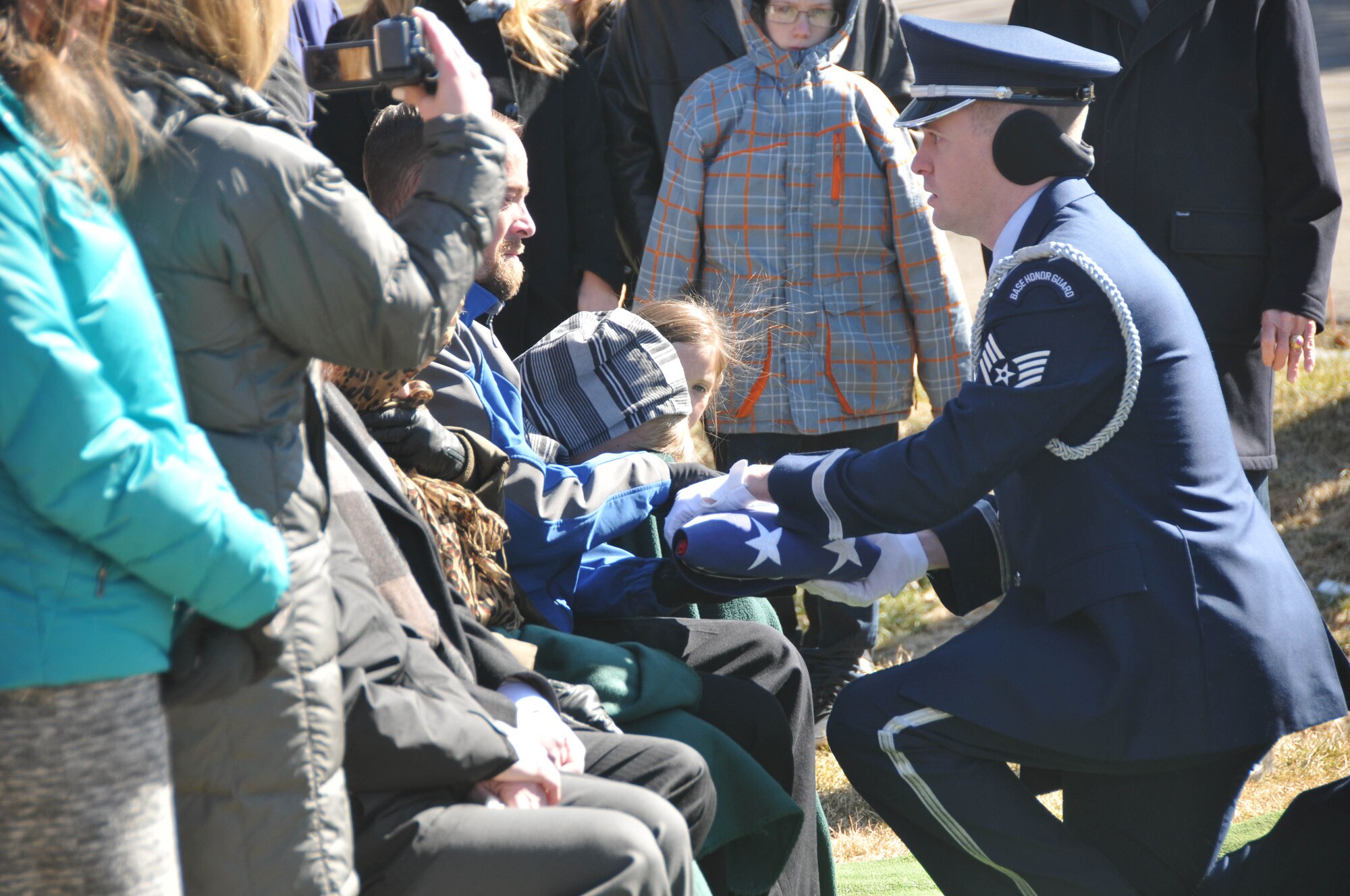 The 934th Airlift Wing Honor Guard presents the U.S. flag to the son of Col. Jerry Driscoll March 1. (Air Force Photo/Capt. William-Joseph Mojica)