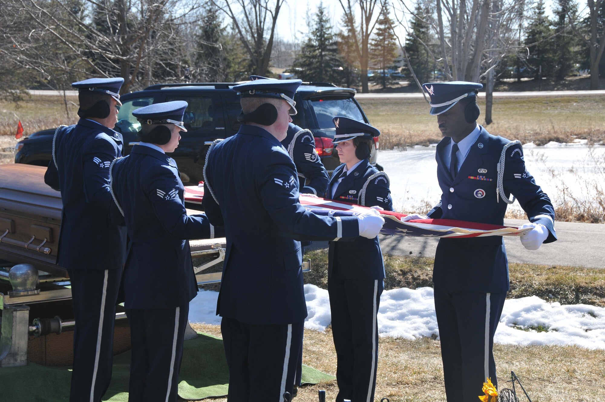 The 934th Airlift Wing Honor Guard performs a flag folding ceremony at the funeral of Col. Jerry Driscoll March 1. (Air Force Photo/Capt. William-Joseph Mojica)