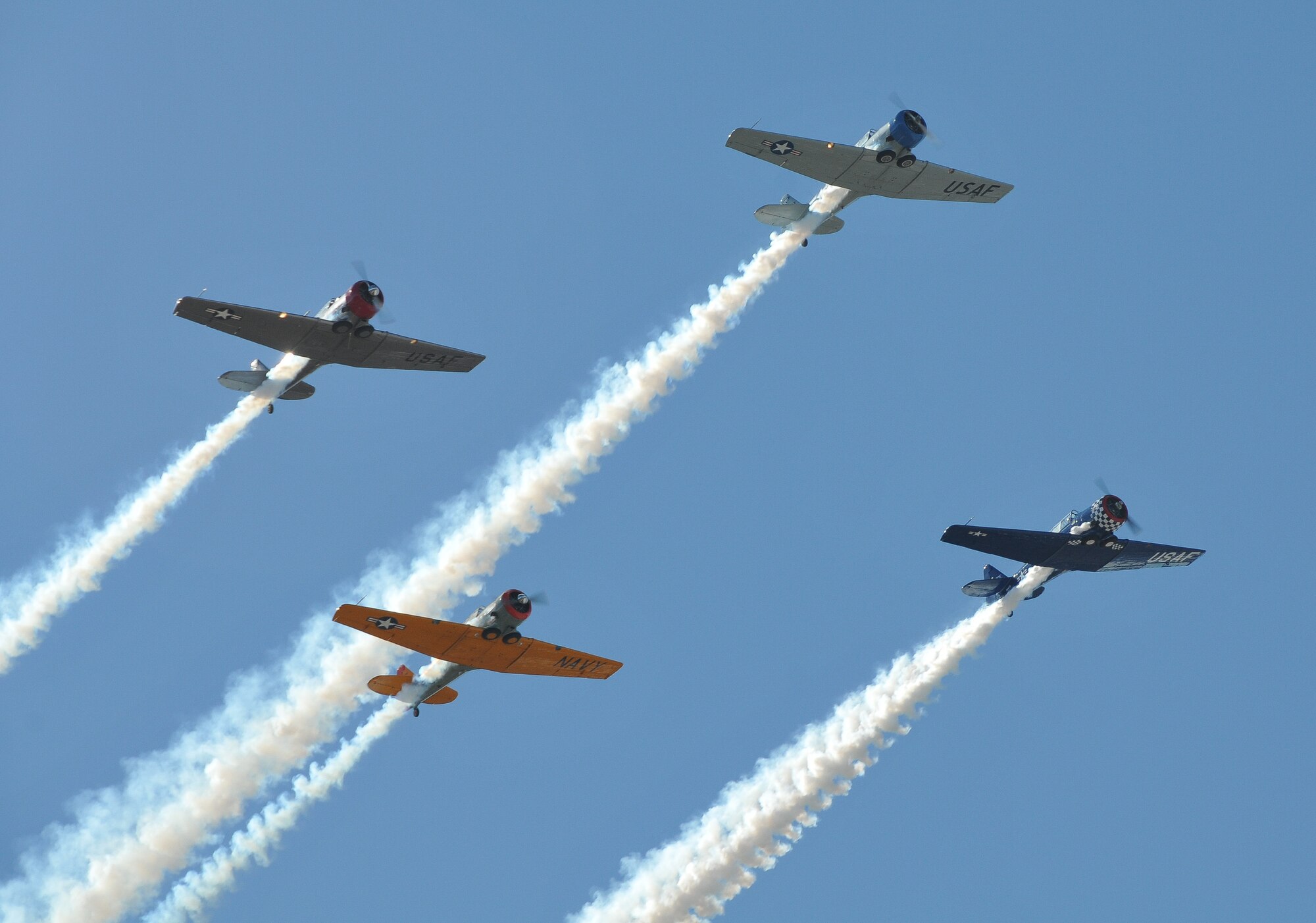 A flight of T-6s perform a flyover at the funeral of Col. Jerry Driscoll March 1. (Air Force Photo/Capt. William-Joseph Mojica)