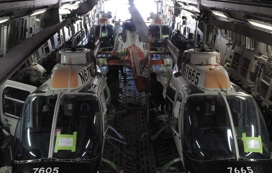 Helicopters sit inside a C-17 Globemaster at the Combat Readiness Training Center, Gulfport, Mississippi, Feb. 26, 2016. Airmen from Keesler Air Force Base, Mississippi, and Soldiers from the CRTC loaded the helicopters for shipping to Columbia for Columbian Air Force helicopter training. (U.S. Air Force photo/Senior Airman Holly Mansfield))