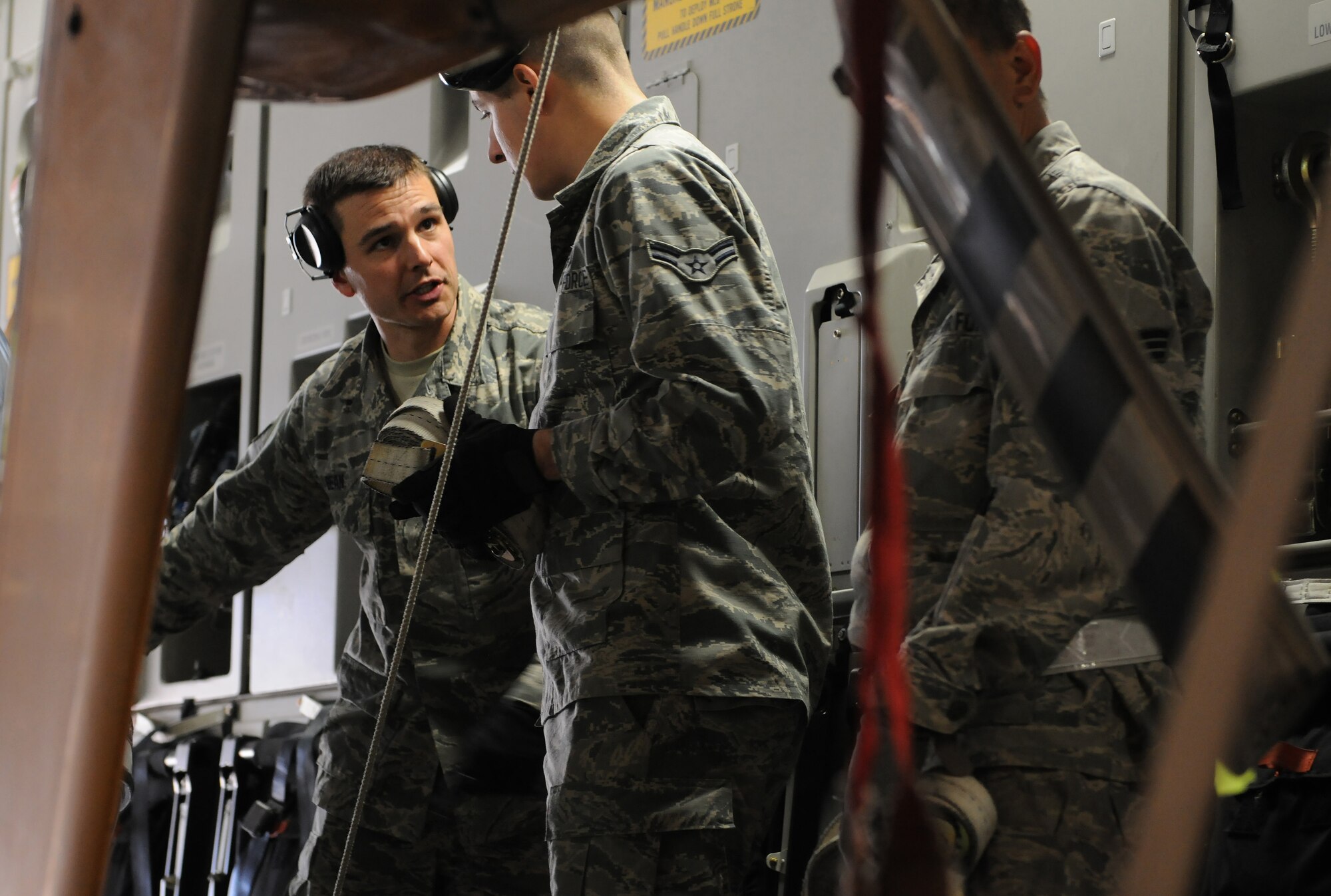 Air transportation specialists from the 41st Aerial Port Squadron, part of the Air Force Reserve’s 403rd Wing at Keesler Air Force Base, Miss., secure helicopters inside a C-17 Globemaster at the Combat Readiness Training Center, Feb. 26, 2016, Gulfport, Miss. The Airmen and Soldiers loaded the helicopters for shipping to Columbia for Columbian Air Force helicopter training. (U.S. Air Force photo by Senior Airman Holly Mansfield)