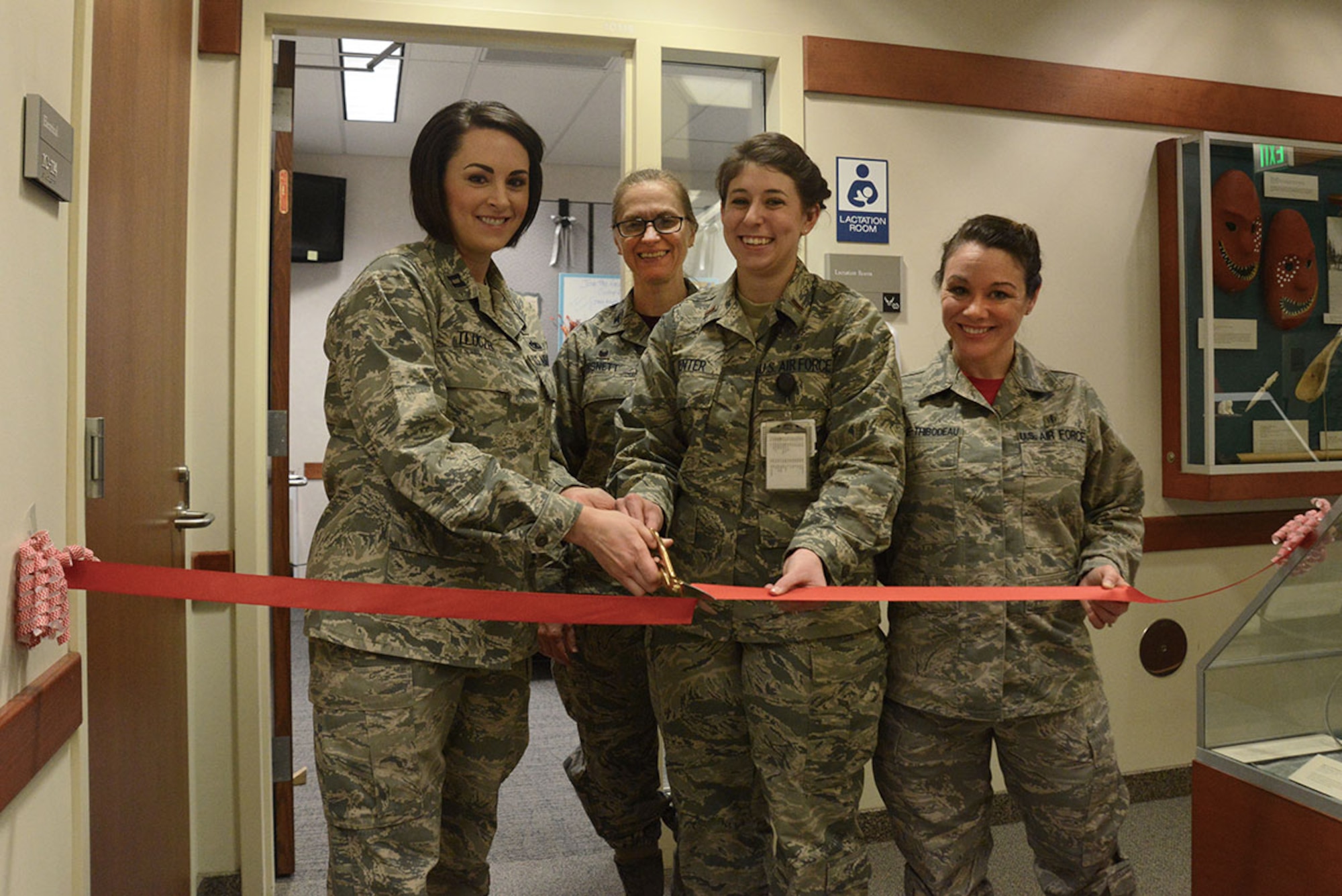 Air Force Col. Teresa Bisnett (middle), Joint Base Elmendorf-Richardson hospital commander; Alaskan Command surgeon, Capt. Donna Tluczek; 2nd Lt. Amy Kenter; and Tech. Sgt. Danielle Gagne-Thibodeau, 673d Surgical Operations Squadron Perianesthesia clinical nurses, cut a ribbon to the lactation room at the JBER hospital Feb. 26, 2016. The room provides mothers a quiet, private area to breastfeed or pump milk. (U.S. Air Force photo by Airman 1st Class Christopher R. Morales)