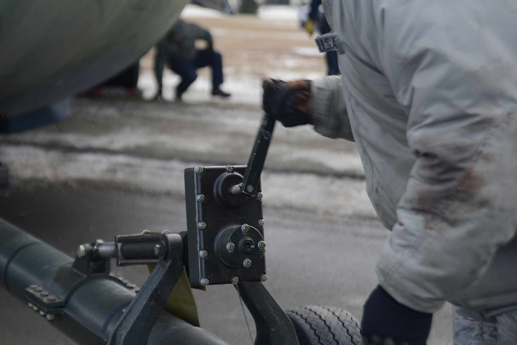 An Airman adjusts the height of the tires on a towing hitch during the static C-130 Hercules move at Joint Base Elmendorf-Richardson Feb. 27, 2016. The towing hitch was necessary for the sharp turns to maneuver around telephone poles. (U.S. Air Force photo by Airman 1st Class Christopher R. Morales)