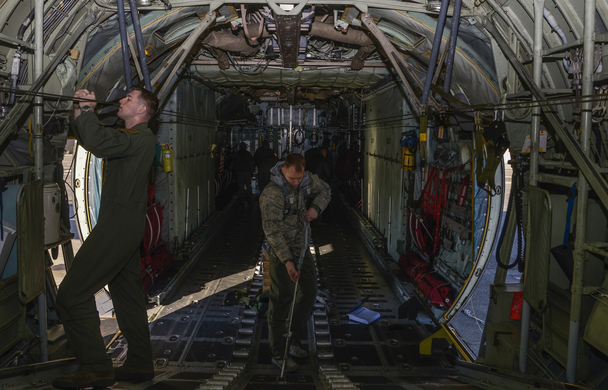 Loadmasters from the 36th Airlift Squadron perform preflight inspections at Yokota Air Base, Japan, March 2, 2016. Loadmasters are responsible for ensuring that the aircraft cargo and passengers are transported safely and in a timely manner. (U.S. Air Force photo by Senior Airman David Owsianka/Released)