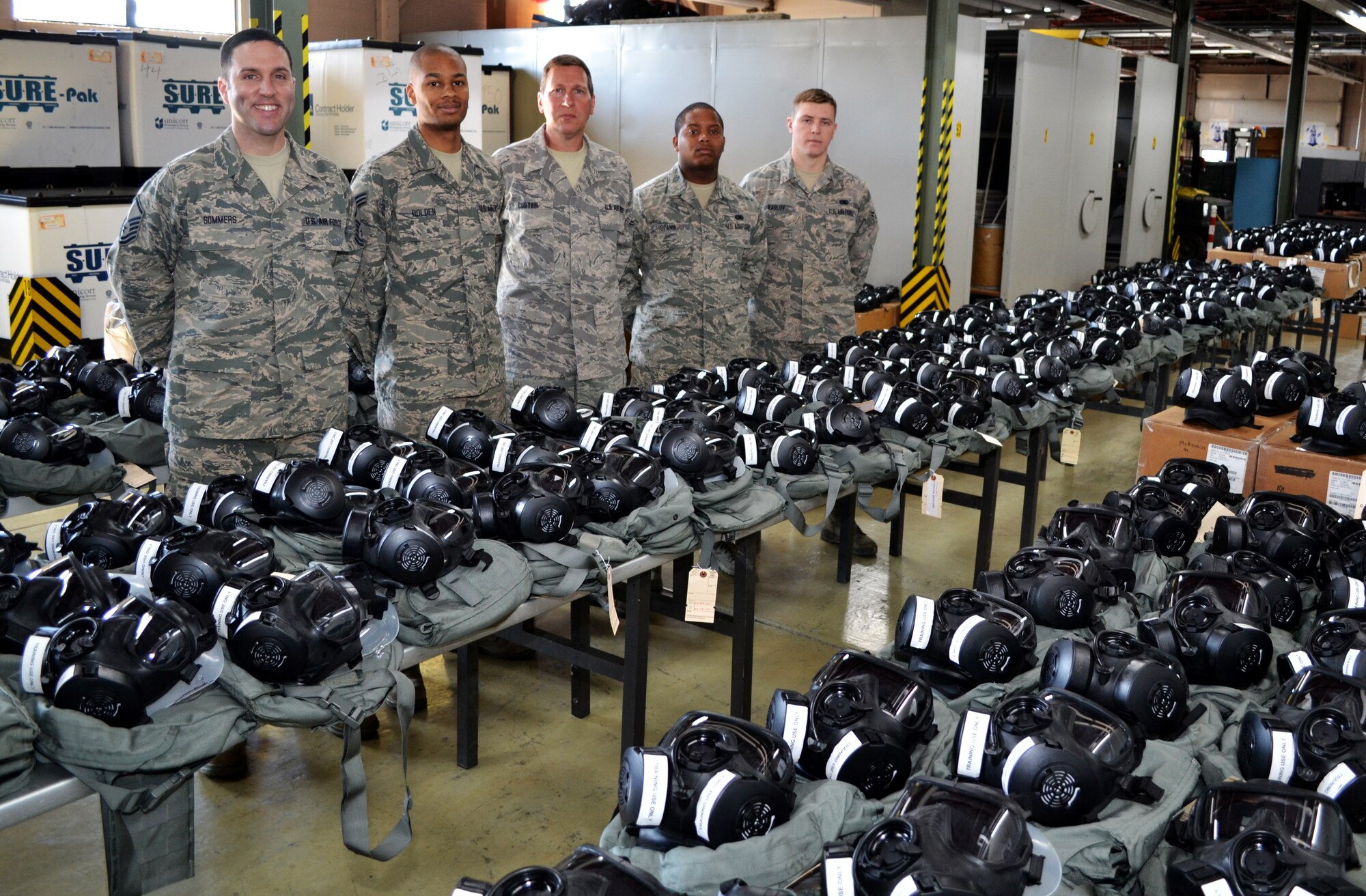 Members of the 111th Logistics Readiness Squadron stand surrounded by all M-50 Joint Service General Purpose Masks issued to 111th Attack Wing members as the masks prepare to undergo leak testing March 2, 2016, at Horsham Air Guard Station, Pa. The Joint Program Executive Office-Chemical, Biological Defense Enterprise Fielding and Surveillance team located at Tyndall Air Force Base, Fl., will be conducting the tests on approximately 750 masks. (U.S. Air Force photo by Tech. Sgt. Andria Allmond)