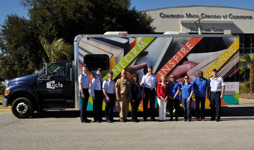 Joint Base Charleston leadership and Berkley County Library System staff members celebrate the new partnership between the P4 program and the BCLS at the Charleston Metro Chamber of Commerce, S.C., March 2, 2016. The bookmobile offers print and digital books, audio books, DVDs and internet capabilities for base residents when the JB Charleston-WS library is closed. (U.S. Air Force photo/Airman Megan E. Munoz)