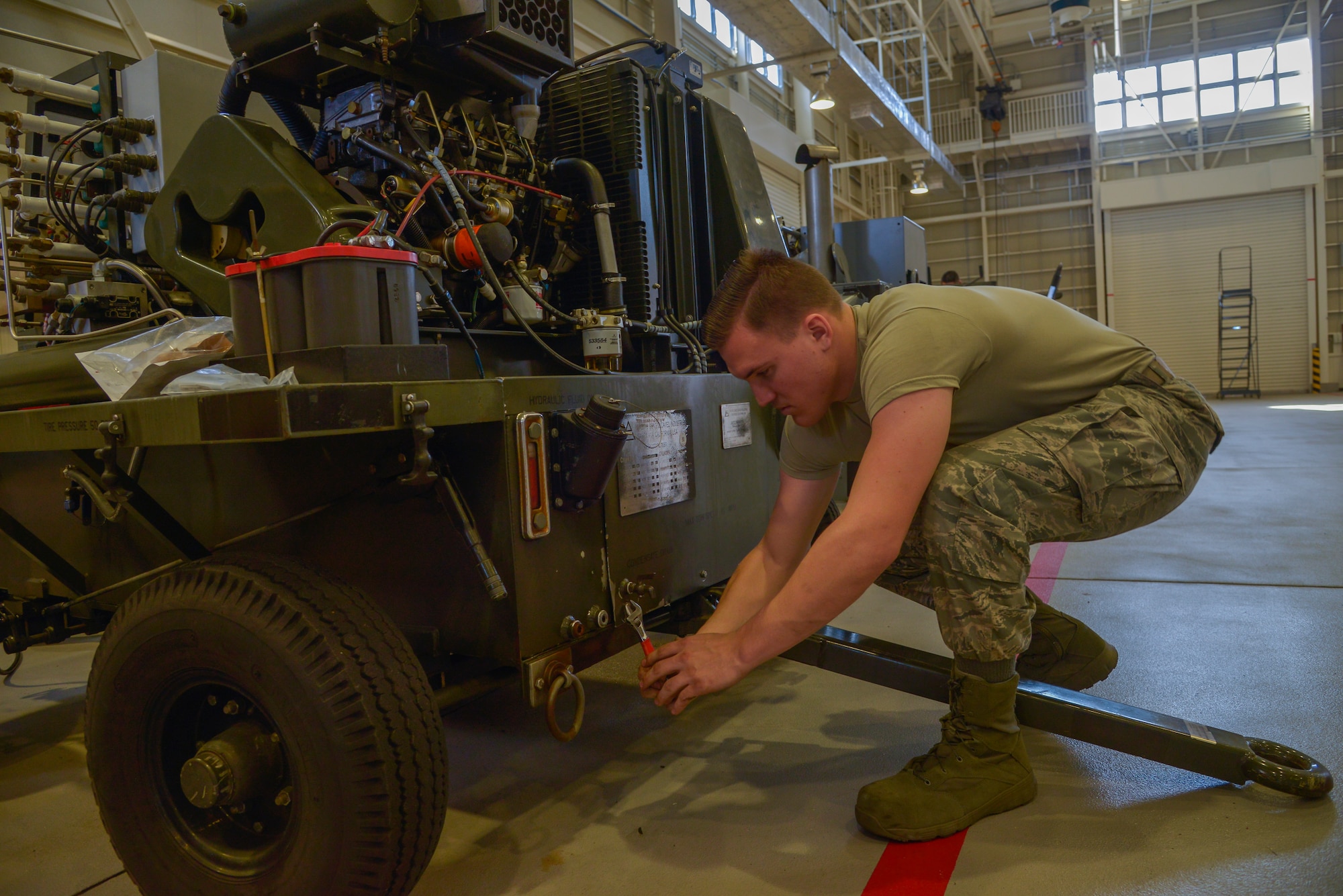 Airman 1st Class Harley Hall, 374th Maintenance Squadron Aerospace Ground Equipment mechanic, tightens a bolt on a diesel generator at Yokota Air Base, Japan, Feb. 11, 2016. The AGE flight is split into five sections: programs, production support, inspection, maintenance and war reserve materials. (U.S. Air Force photo by Senior Airman David Owsianka/Released)