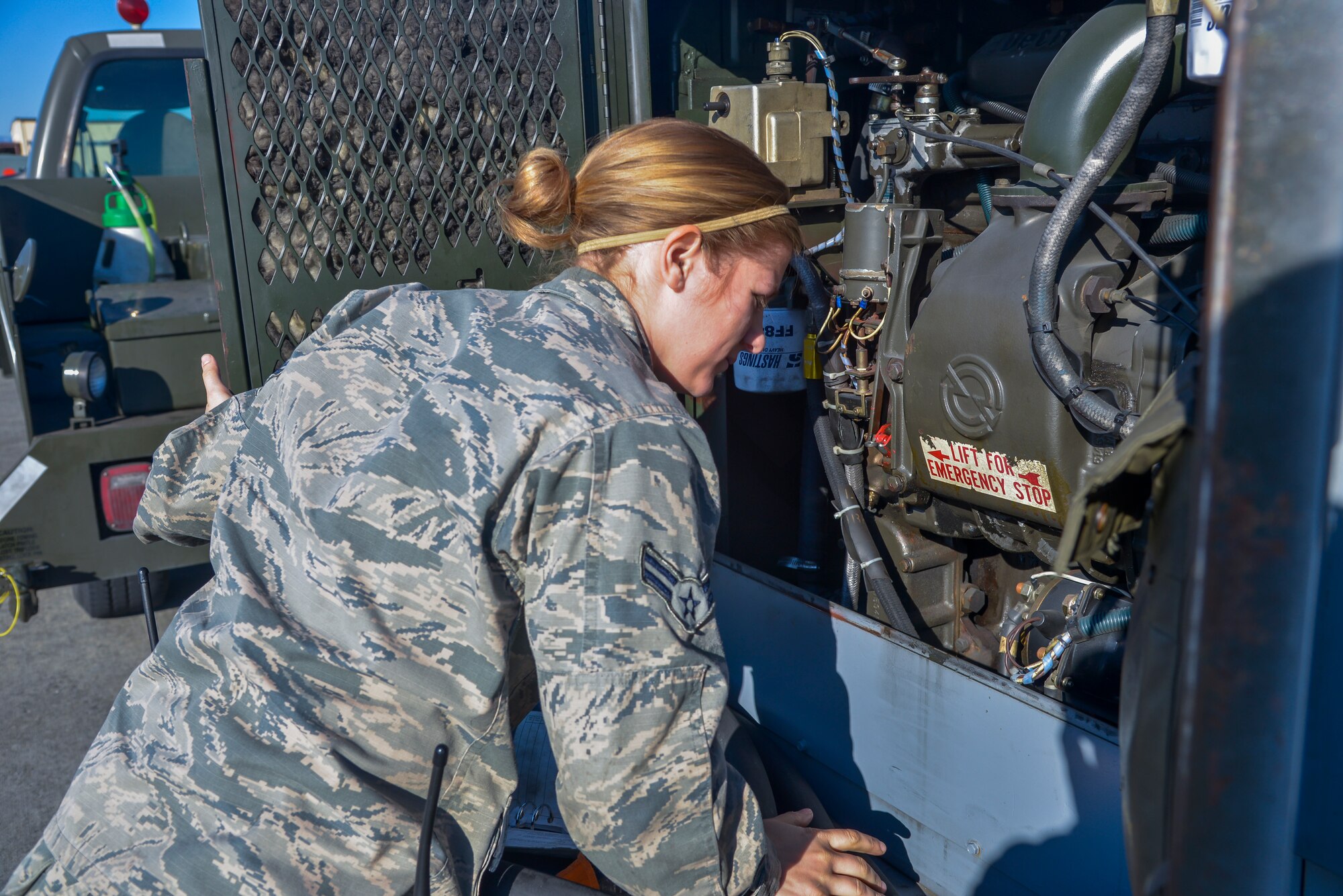 Airman 1st Class Abigail Kuras, 374th Maintenance Squadron Aerospace Ground Equipment apprentice, performs a service inspection on a diesel generator at Yokota Air Base, Japan, Feb. 11, 2016. The AGE flight maintains, services and repairs 408 assets that support the base’s mission. (U.S. Air Force photo by Senior Airman David Owsianka/Released)