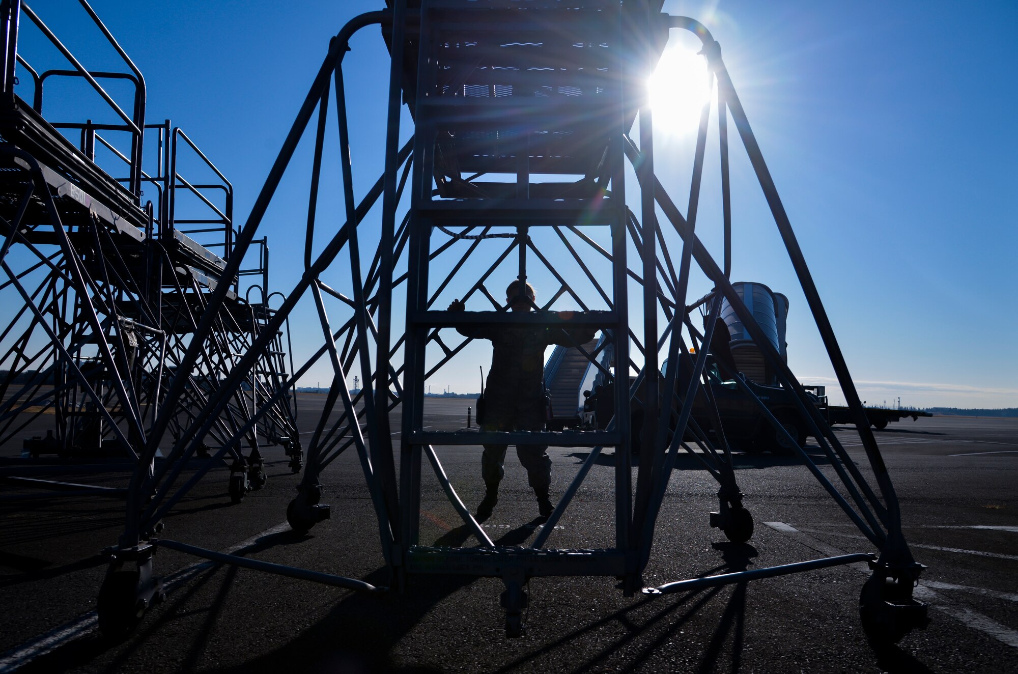 Airman 1st Class Abigail Kuras, 374th Maintenance Squadron Aerospace Ground Equipment apprentice, returns a stand to its storage area at Yokota Air Base, Japan, Feb. 11, 2016. The stands help maintainers access various parts of the aircraft that are too high to reach from the ground. (U.S. Air Force photo by Senior Airman David Owsianka/Released)