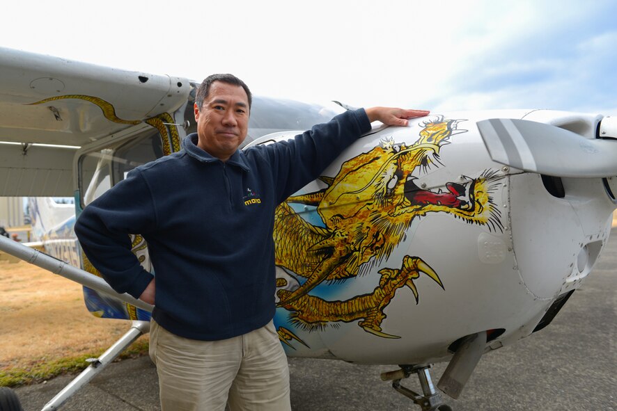 Masayoshi Nakano, Yokota Aero Club and Flight Training Center flight instructor, poses with one of the Yokota Aero Club Cessnas at Yokota Air Base, Japan, Feb. 22, 2015. Nakano has been flying for 24 years, nine of which have been with the aero club where he instructs students and takes customers for scenic  flights over Tokyo. (U.S. Air Force photo by Airman 1st Class Elizabeth Baker/Released)