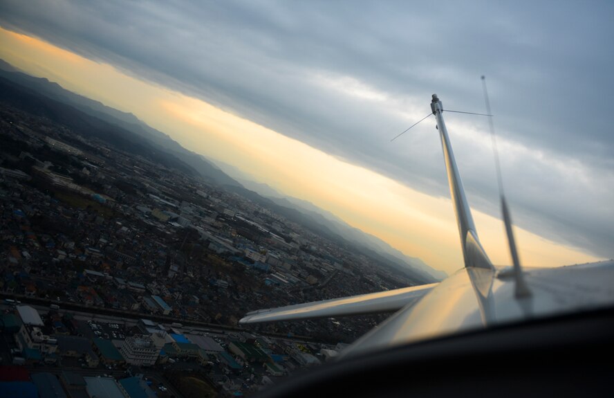 A Yokota Aero Club and Flight Training Center Cessna banks over Tokyo, Japan, Feb. 22, 2015. Yokota aero club aircraft and facilities have received multiple awards for safety, quality maintenance and customer service. (U.S. Air Force photo by Airman 1st Class Elizabeth Baker/Released)