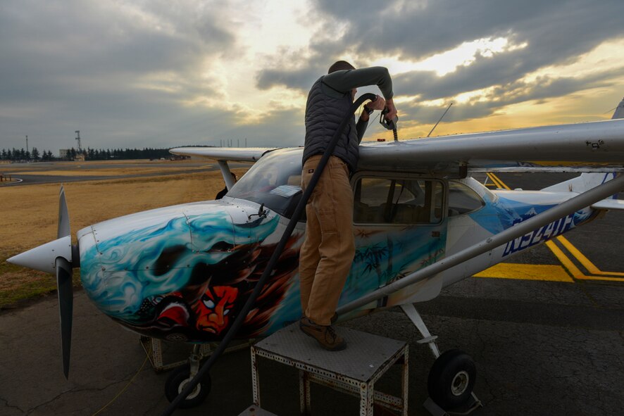 Lt. Col Andrew Campbell, 36th Airlift Squadron commander and Yokota Aero Club and Flight Training Center student, fuels his aircraft before flying at Yokota Air Base, Japan, Feb. 22, 2015. Students working to receive their single-engine pilot’s license learn to do all pre and post-flight checks. (U.S. Air Force photo by Airman 1st Class Elizabeth Baker/Released))