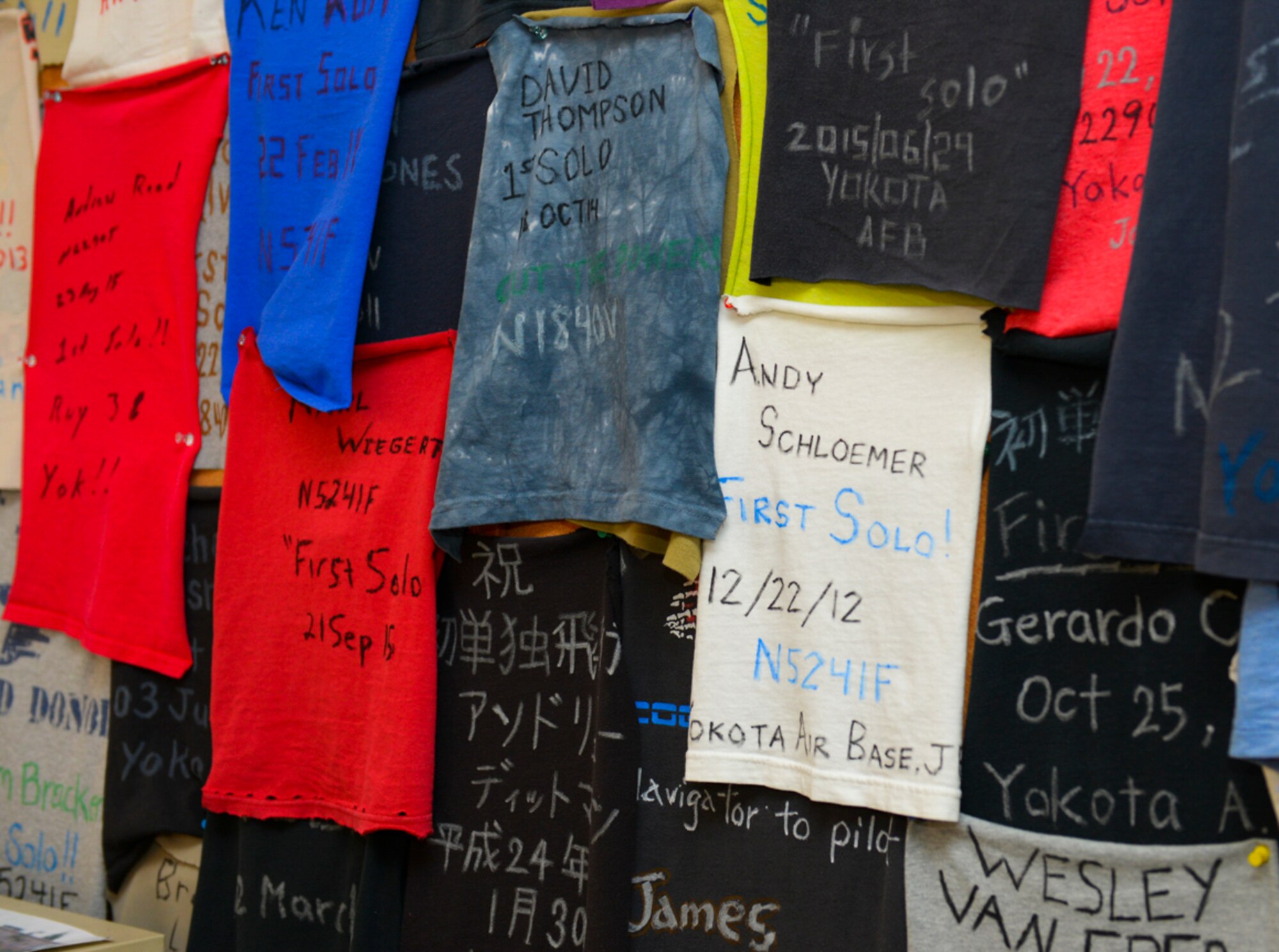 Hand-written commemorations from students after their first solo flights sit on the wall at the Yokota Aero Club and Flight Training Center at Yokota Air Base, Japan, Feb. 22, 2015. Single engine pilot’s license students spend between 10-15 hours flying a Cessna with an instructor before they can begin solo flights. (U.S. Air Force photo by Airman 1st Class Elizabeth Baker/Released)