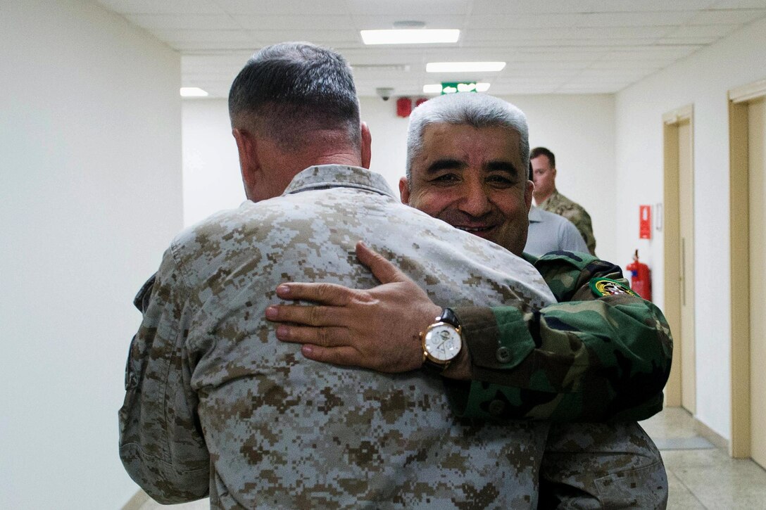 Afghan Lt. Gen. Qadam Shah Shameem, chief of armed forces, and U.S. Marine Corps Gen. Joseph F. Dunford Jr., chairman of the Joint Chiefs of Staff, embrace before a meeting at the Ministry of Defense in Kabul, Afghanistan, March 2, 2016. DoD photo by D. Myles Cullen