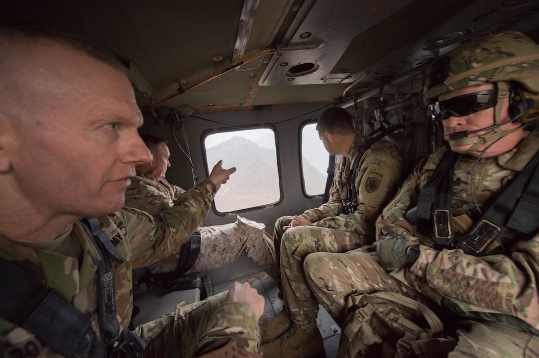 Army Command Sgt. Maj. John W. Troxell, senior enlisted advisor to the chairman of the Joint Chiefs of Staff, left, talks to Army Brig. Gen. Michael Howard while on-board a UH-60 Black Hawk helicopter flying to Forward Operating Base Fenty in Jalalabad, Afghanistan, March 2, 2016. DoD photo by D. Myles Cullen